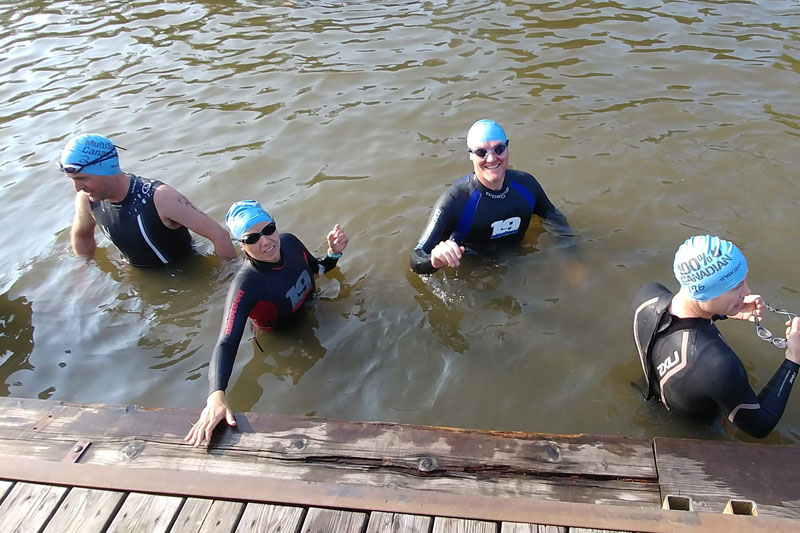 DRTC members in the water in their wetsuits and swim caps